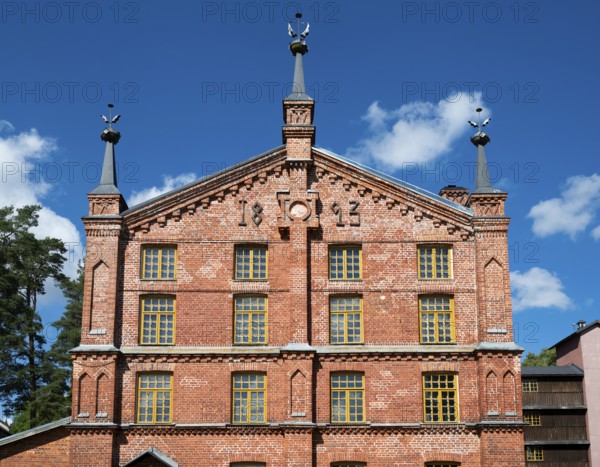Multi-storey brick façade with inscription 1893, former paper factory and mill for the production of groundwood pulp board, UNESCO World Heritage Site Factory Village Verla, Maailmanperintökohde Verlan puuhiomo ja pahvitehdas, Verla Rapids, Kymenlaakso, near Kouvola, Finland