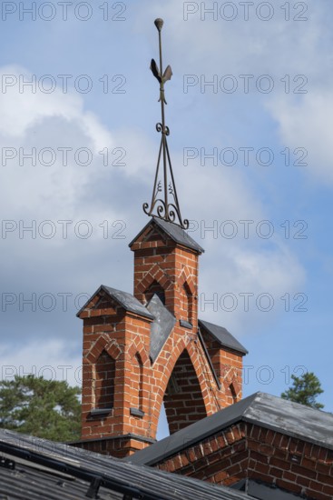 Iron ornamental element on roof peak, brick gable, former paper mill for the production of groundwood pulp board, UNESCO World Heritage Site Factory Village Verla, Maailmanperintökohde Verlan puuhiomo ja pahvitehdas, Verla Rapids, Kymenlaakso, near Kouvola, Finland