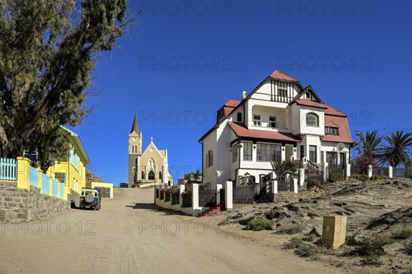 Colonial house facade in the Kirchstraße, in the background the rock church, Lüderitz, Karas region, Namibia