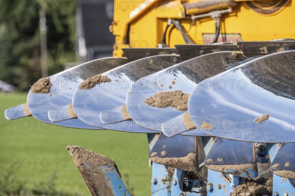Plough, for ploughing a field, field, ploughshares, agricultural technology, shiny stainless steel, North Rhine-Westphalia, Germany