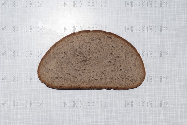 Top shot of a slice of bread on a white Resopal plate