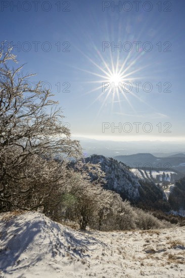 View over the hills and valleys from the mountain with hoarfrost on the branches in winter, Vápec, Horná Poruba, Slovakia