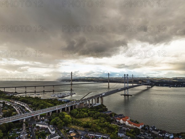 Rain clouds over Forth Road Bridge and The Queensferry Crossing from a drone, Queensferry Crossing, Forth Estuary, Scotland, United Kingdom