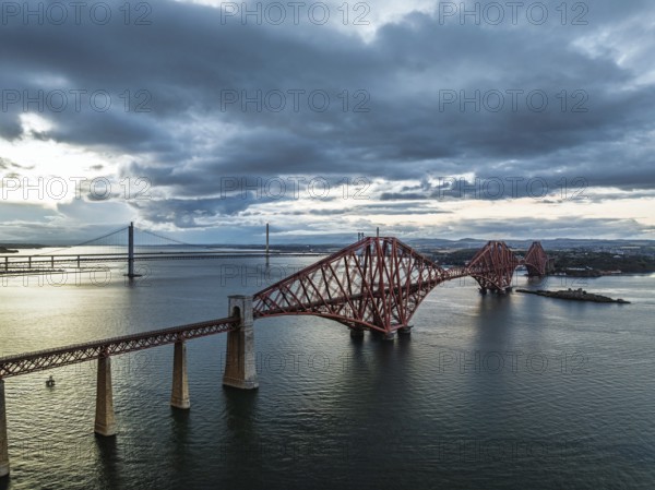 Rain clouds over Forth Bridge from a drone, Queensferry Crossing, Forth Estuary, Scotland, United Kingdom