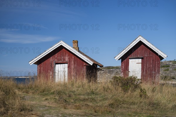 Falun red or Swedish red boathouses by the sea, Resö Island, Bohuslän, Skagerrak, Sotenäs, Västra Götalands län, Sweden