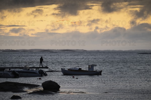 Small bay, archipelago, jetty with angler, Resö Island, Bohuslän, Skagerrak, Sotenäs, Västra Götalands län, Sweden