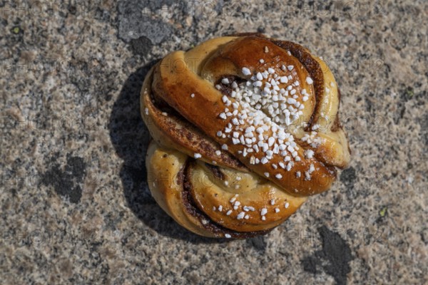 Kanelbulle or cinnamon bun with sugar, Swedish pastry speciality, Sweden