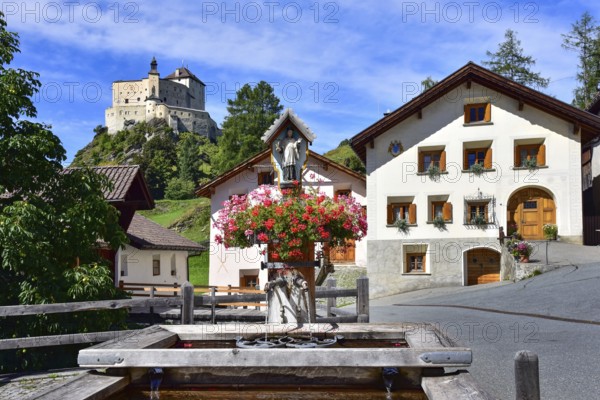 Village fountain in Tarasp, municipality of Scuol, in the background Tarasp Castle in the Lower Engadine, Grisons, Switzerland