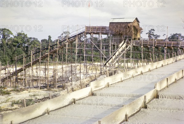 Open Cast gravel-pumping tin mine Malaya, Malaysia, south east Asia 1964 - Ore separation in the Palong, the palong acts as a processing sluice with riffles or bars