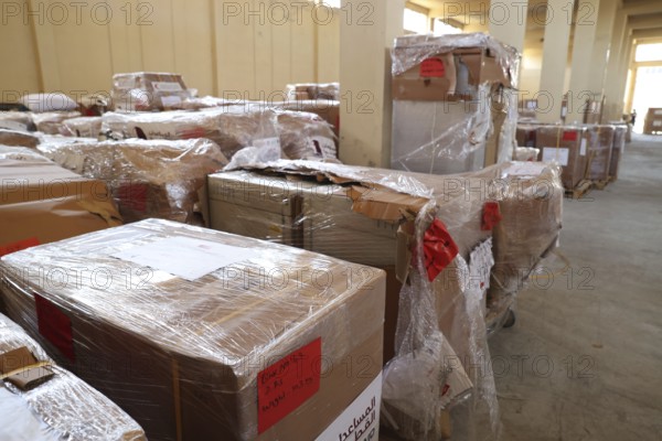Relief workers unload boxes of medical aid provided by Qatar at Damascus International Airport, part of the humanitarian bridge supporting Syria's recovery and reconstruction after the fall of Bashar al-Assad, Damascus, Damascus, Syria