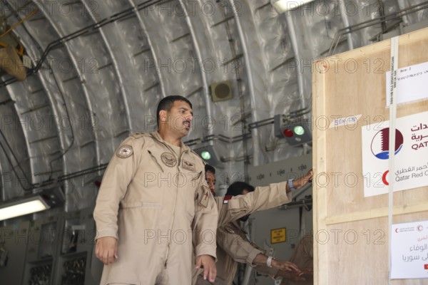 Members of the Qatari Air Force unload humanitarian aid supplies from a transport aircraft at Damascus International Airport as part of Qatar's air and land relief bridge to Syria, Damascus, Damascus, Syria