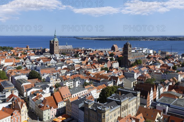 View from a height of 84 metres over the city, Neuer Markt below, St. Nikolai Church to the rear left, St. Jakobi Church to the right, Rügen Island behind, St. Mary's Church, also known as Marienkirche, basilica, late Gothic, three naves with transept, first mentioned in 1298, Neuer Markt, Old Town, UNESCO World Heritage Site, Hanseatic City of Stralsund, Mecklenburg-Western Pomerania, Germany