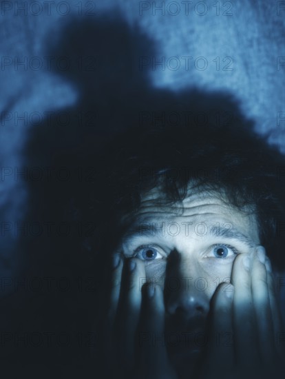 A close-up of a man whose face is marked by fear, symbolising anxiety disorders, panic attacks, mental illness, AI generated, AI generated