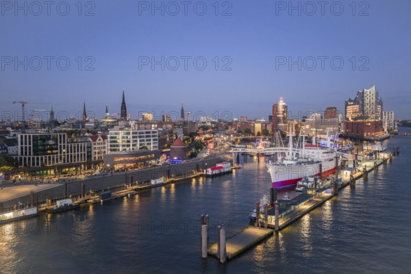 Aerial view of the Landungsbrücken Hamburg (Jan-Fedder-Promenade) at blue hour with Elbe, Cap San Diego and Elbphilharmonie in the background, Hamburg, Germany