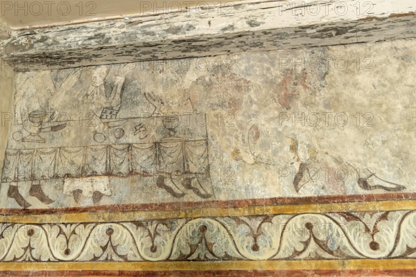 Saint Jean Chapel features ancient wall paintings showcasing religious figures with vibrant colors and intricate details. Champeix village. Puy de Dome. Auvergne Rhone Alpes. France