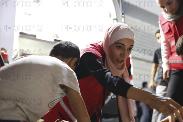 Syrian Arab Red Crescent volunteers conduct first aid training for children during the Damascus International Fair, the first edition held after the fall of Bashar al-Assad. The activity raises awareness of health, safety, and emergency preparedness among young visitors, Damascus, Damascus, Syria