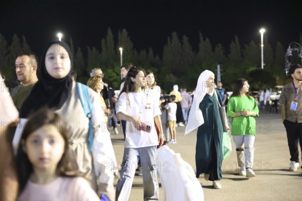 Audience members enjoy a musical performance during the Damascus International Fair in Damascus, Syria, attended by local citizens and international guests, Damascus, Damascus, Syria