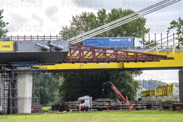 New construction of the second motorway bridge Neuenkamp of the A40, over the Rhine near Duisburg, parallel to the already existing first bridge, most of the new bridge piers are in place, two first bridge segments are finished and have already been moved towards the river on both sides of the Rhine, full completion is planned for 2028, North Rhine-Westphalia, Germany