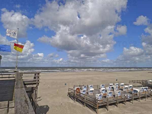 North Sea beach, blue sky, white clouds, summer, sun, sand, beach chairs on pedestal, flags, on the edge of the UNESCO World Heritage Site, Ording, Sankt Peter-Ording, Schleswig-Holstein, Germany