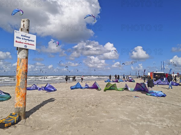 California kitesurfing Masters 2025, kitesurfing on the North Sea beach on the edge of the UNESCO World Heritage Wadden Sea, sports competition, strong wind, high swell, no swimming sign, whitecaps, summer, sun, blue sky, white clouds, Ording, Sankt Peter-Ording, Schleswig-Holstein, Germany