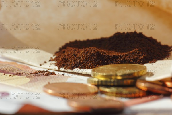 Ground coffee in a filter bag with coins and a ten euro note in front of it, North Rhine-Westphalia, Germany