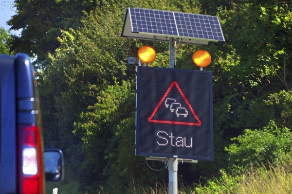 Traffic sign with solar-powered traffic jam warning on the motorway, Baden-Württemberg, Germany