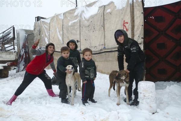 Displaced Syrian families and children living in refugee camps during harsh winter conditions, facing snow, cold weather, and difficult humanitarian circumstances. Aleppo, Syria January 01, 2022, Aleppo, Syria