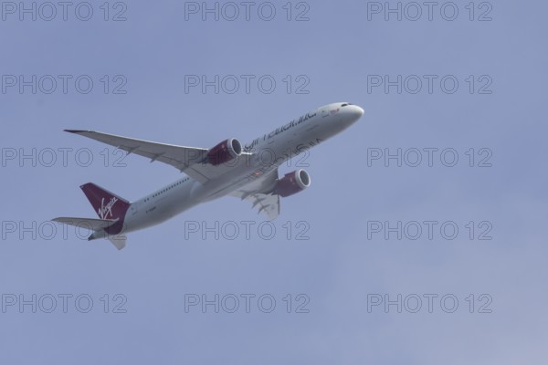 Boeing 787 Dreamliner jet passenger aircraft of Virgin Atlantic airlines in flight in a blue sky, England, United Kingdom