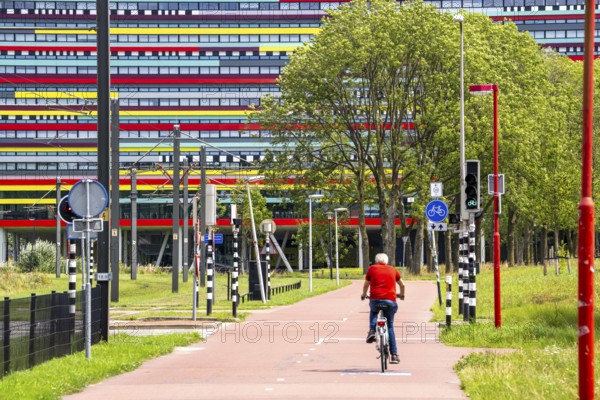 Cycle path through the university campus in Utrecht Science Park, Utrecht University, colourful facade of the Hogeschool Utrecht building, Netherlands