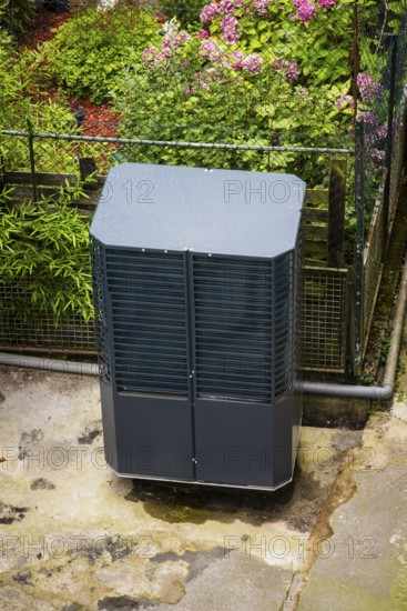 Heat pump in a backyard in Wuppertal, Germany, digitally reworked