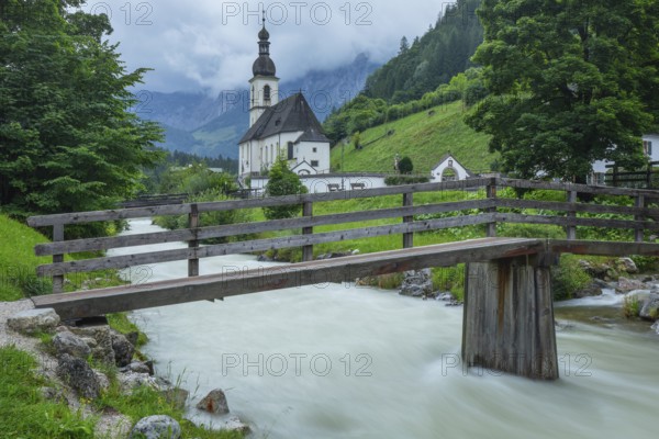 St Sebastian in Ramsau in Berchtesgadener Land with rain clouds after heavy rain