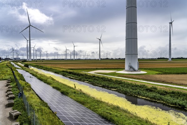 Solar park on the Slaperdijk dyke near Eemshaven, test project, 17, 000 solar modules were installed over a good 5 kilometres, the Netherlands has over 22, 000 kilometres of dyke line, here it is being tested whether such an installation is successful and can be expanded, wind farm, Netherlands
