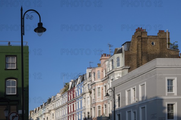 Terraced houses, townhouses with different, colourfully painted facades under a blue sky, Portobello Road, Notting Hill, London, England, Great Britain