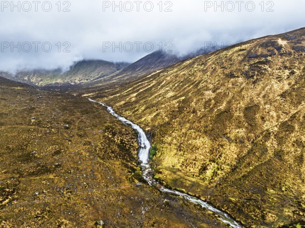 Eas a' Bhradain Waterfall from drone, Red Cuillin mountains, Loch Ainort, Isle of Skye, Scotland, UK