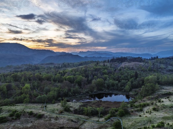 Sunset over Mountains and Coniston Water from drone, Lake District National Park, Cumbria, England, United Kingdom