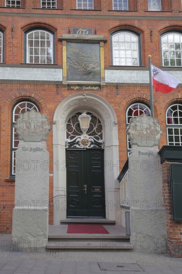 Entrance to the Schiffergesellschaft restaurant with painting, brick building, Old Town, Lübeck, Schleswig-Holstein, Germany