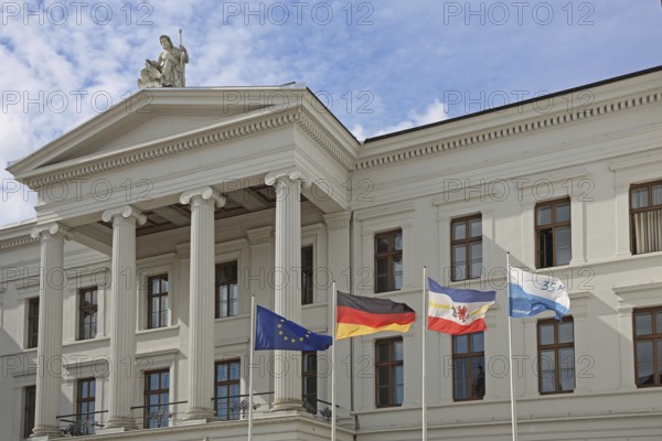 Portal with columns and EU flag, German national flag and Mecklenburg-Vorpommern state flag on the classicist government building, state chancellery, college building, white palace, Schwerin, Mecklenburg-Vorpommern, Germany