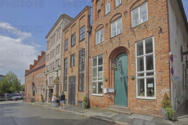Restaurant Nachtschwärmer with nose sign, pedestrian, brick building, houses, Alfstraße, Old Town, Lübeck, Schleswig-Holstein, Germany