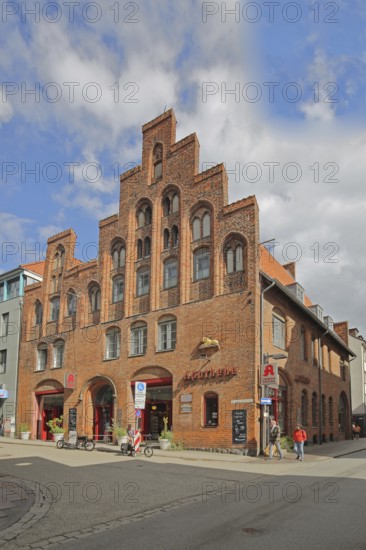 Historic lion pharmacy with stepped gable, brick building, pedestrian, pharmacy, old town, Lübeck, Schleswig-Holstein, Germany
