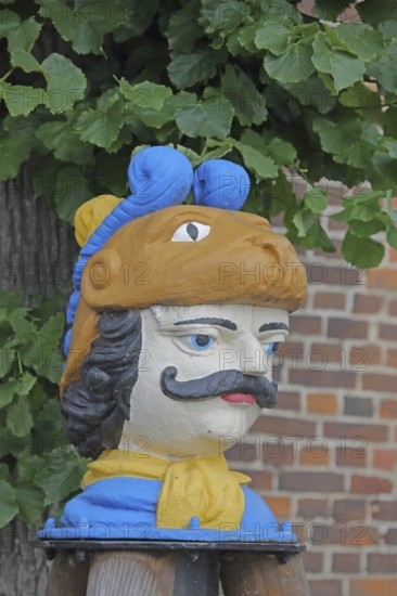 Colourful Swedish head as a landmark, historic wooden head with face and four eyes, tree house, Old Harbour, Wismar, Mecklenburg-Western Pomerania, Germany