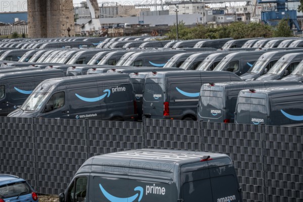New delivery vehicles for the online mail order company Amazon Prime, with electric drive, are waiting for delivery in the inland port of Duisburg, Duisport, North Rhine-Westphalia, Germany