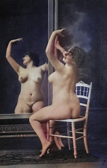 Female nude from around 1899, erotic postcard, Playgirl, A woman posing naked in front of a large mirror with a white chair in the foreground, coloured, reproduction from a photo around the turn of the century, Historical, digitally restored reproduction of an old original, exact date unknown