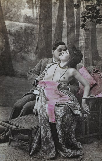 Female nude from around 1899, erotic postcard, playgirl, romantic couple in an intimate moment on a park bench in a forest, coloured, reproduction from a photo around the turn of the century, historical, digitally restored reproduction of an old original, exact date unknown