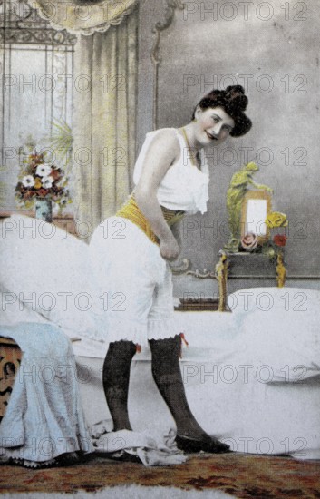 Female nude from around 1899, erotic postcard, playgirl, woman in historical underwear dressing in a stylish bedroom, coloured, reproduction of a photo from around the turn of the century, historical, digitally restored reproduction of an old original, exact date unknown