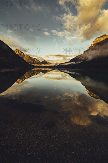 Sunrise with reflections in Lake Heiterwanger See in Tyrol in the Alps in Austria