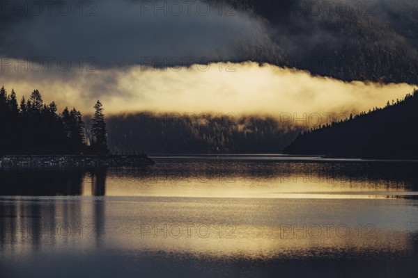 Sunrise with reflections in Lake Heiterwanger See in Tyrol in the Alps in Austria