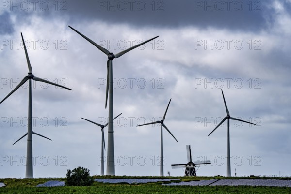 Westereems and Growind wind farms, over 80 wind turbines in total, at the seaport of Eemshaven, province of Groningen, in the north-west of the Netherlands, historic Goliath windmill from 1897, solar farm on sea dike, Slaperdijk, a good 5 kilometres long
