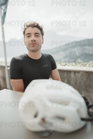 Young man riding a racing bike on Lake Garda. Sunny weather and dolce vita