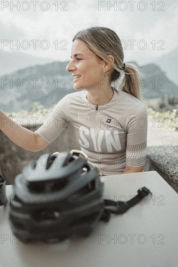 Young woman riding a racing bike on Lake Garda. Sunny weather and dolce vita