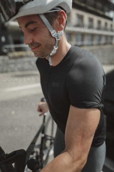 Young man riding a racing bike on Lake Garda. Sunny weather and dolce vita